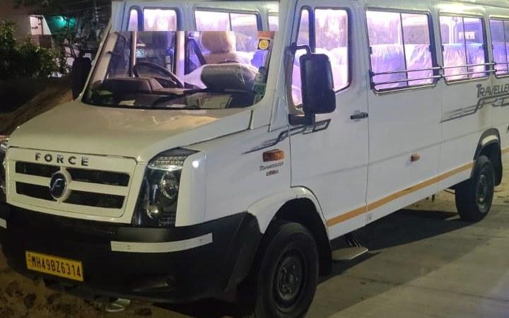 White Force Tempo Traveller waiting for a corporate pickup